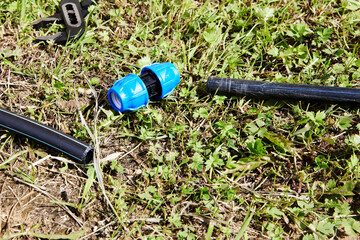 Installation of watering pipeline, connecting fitting for HDPE pipes will connect two parts of water supply.