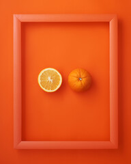 Orange in picture frame on orange background