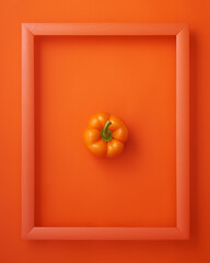 Bell pepper in frame on orange background