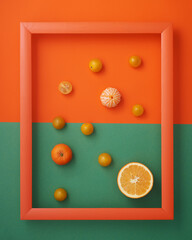 Orange, clementines and cherry tomatoes in wooden picture frame