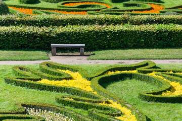 Colorful blooming floral and hedge ornaments in the glow of the summer sun in Kroměříž