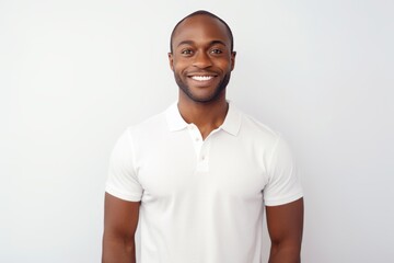 Portrait of a blissful afro-american man in his 30s donning a classy polo shirt in white background