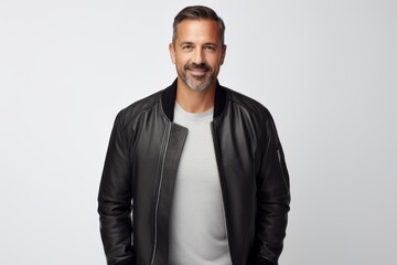 Portrait of a satisfied man in his 40s wearing a trendy bomber jacket in white background