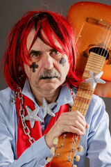 Portrait of an old crazy musician with a guitar - 786396930