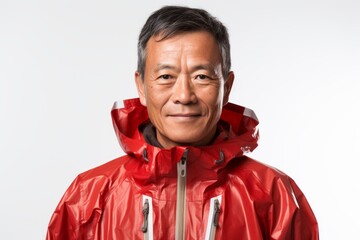 Portrait of a content asian man in his 60s sporting a waterproof rain jacket isolated on white background