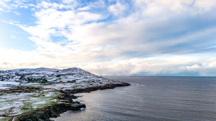 Aerial view of snow covered Dunmore Head, Bunaninver and Lackagh by Portnoo in County Donegal, Ireland.