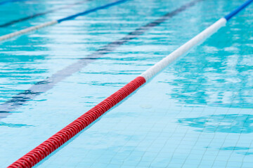 competition pool with blue water and marked swimming lanes - 786403757