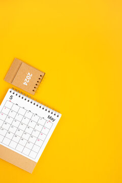 2024 May Desk Calendar On Yellow Background, Position with copy space On Yellow Background.