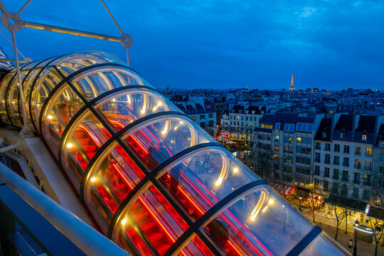 Escalator in Centre Pompidou (or Beaubourg), view on the roofs of Paris and the Eiffel tower at night