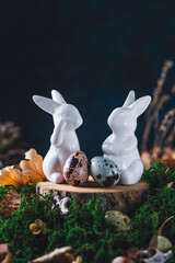 Easter bunnies next to painted quail eggs