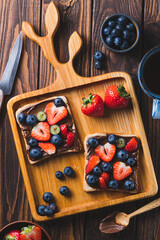 Sandwich with chocolate paste and strawberries and blueberries