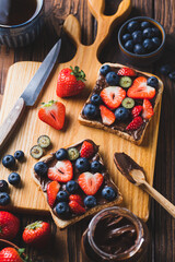 Sandwich with chocolate paste and strawberries and blueberries