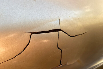 swollen, cracked paint on a car. a road accident