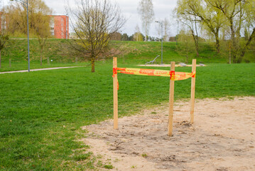 Fototapeta na wymiar empty playground in the park. the site is fenced off with orange stop tape. renovations are underway