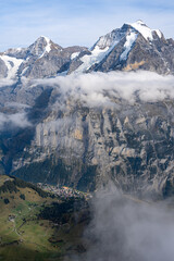 View of Lauterbrunnen valley in Swiss Alps. Bright sunny day with low clouds in Switzerland