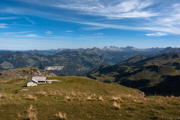 Mountain hut and cable car seen from Fronalpstock summit, Switzerland. Swiss Alps iconic view