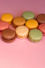 Colorful macarons on pink background. Selective focus.