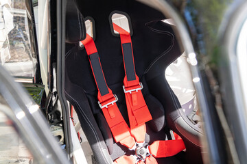 Racing car safety seat with red seat belts