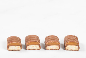 Cookies with caramel in chocolate glaze. In the section. White background. Close-up. Copy space