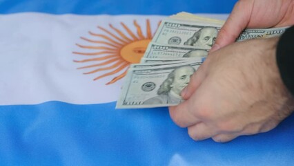 hand with money and argentina flag - Powered by Adobe