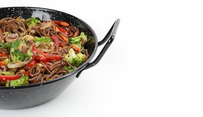 Stir-fry. Tasty noodles with meat and vegetables in wok on white background, space for text