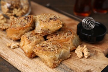 Eastern sweets. Pieces of tasty baklava on wooden table, closeup