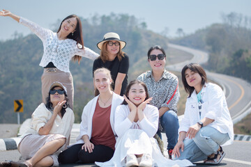 Group of asian female travellers standing by the rural road, like number 3, on high mountain during summer travelling vacation, soft focus, asian travel lifestyle concept.