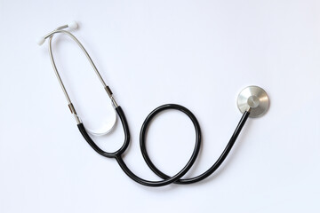Stethoscope on a white background, top view. Medical instrument. Cardiology and medicine concept, healthcare. Auscultation device