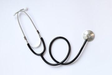 Stethoscope on a white background, top view. Medical instrument. Cardiology and medicine concept,...