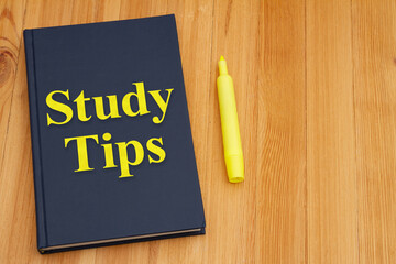 Study Tips with retro old blue book with highlighter marker on a desk - 786438595