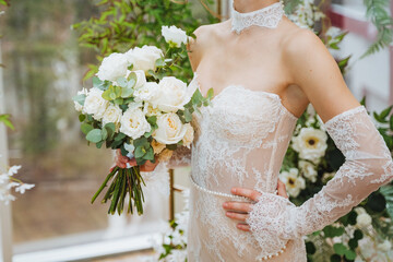 Bride in wedding gown with a bouquet of white flowers
