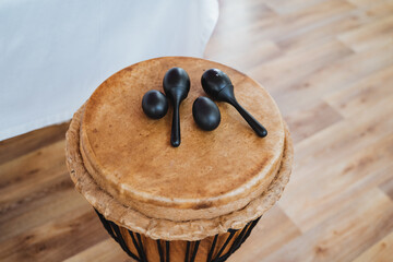 Wooden drum with spoon attachments on hardwood floor