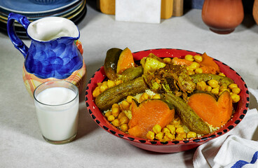 Meat and vegetable couscous in a tajine plate, typical food from Algeria, a traditional festive Arabic dish with herbs and spices
