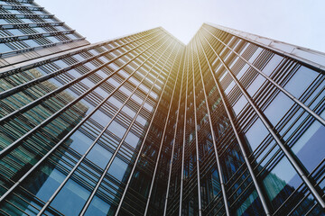 Glass Skyscraper Reaching into Sunny Sky - obrazy, fototapety, plakaty