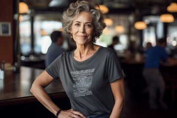 Fototapeta premium Portrait of a blissful woman in her 60s dressed in a casual t-shirt while standing against bustling city cafe