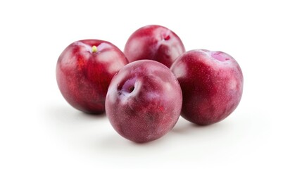 Plum colored plums set apart against a white background