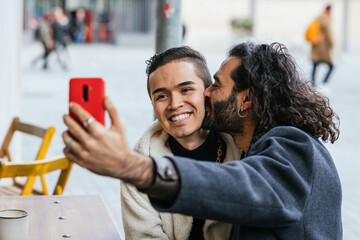Affectionate gay couple taking a selfie