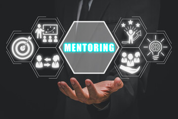 Mentoring concept, Businessman hand holding goals, mentoring, support, success, motivation and coaching icon on virtual screen.