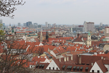 Obraz premium View of the Old Town from the Castle Hill, Bratislava, Slovakia. Street view, old red roofed houses. Spring in Europe. 