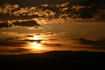 Sun behind orange clouds desert sunset Southwest 