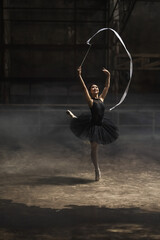 Young ballerina girl preforming ballet dance with ribbon