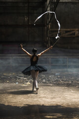 Young ballerina girl preforming ballet dance with ribbon