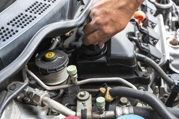 Close up car mechanic doing car maintenance in auto repair service