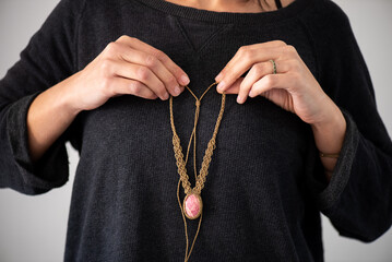 woman's hand in the shape of a heart, macrame woven thread necklace with an inlaid rhodochrosite...
