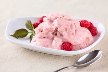 Raw vegan banana ice cream with raspberries.