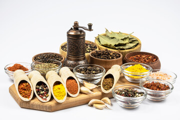 Assortment of oriental spices on kitchen board isolated on white background.