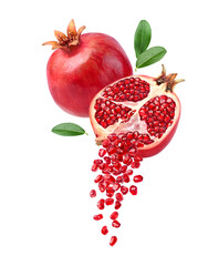 Pomegranate seeds falling from cut in half fruit isolated on white background.