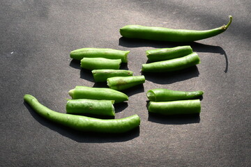 Green beans on black background. Its other names names French beans, string beans, snap beans, snaps, and the French name haricot vert. Popular vegetable of all over world. 
