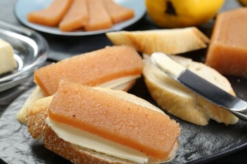 Tasty sandwiches with quince paste on table, closeup