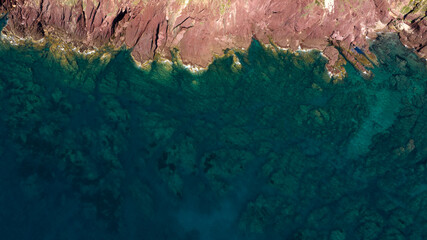 Aerial view on cliffs rich in ferrous material in southern Sardinia, Italy.